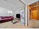 Basement with carpet, television, and access to an unfinished room at 1991 Flat Shoals Rd, Riverdale, GA 30296