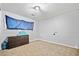 This bedroom has a large window for natural light, a dresser, and carpet flooring at 1991 Flat Shoals Rd, Riverdale, GA 30296