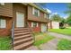 Two-story home with brick accents, stairs leading to the front door and an attached one-car garage at 1991 Flat Shoals Rd, Riverdale, GA 30296