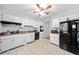 Kitchen featuring tile floors, white cabinets, and black appliances at 1991 Flat Shoals Rd, Riverdale, GA 30296