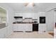 Bright kitchen boasts white cabinets, modern appliances, and ample counter space for cooking and meal preparation at 1991 Flat Shoals Rd, Riverdale, GA 30296