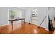 Bright living room featuring hardwood floors, gray walls, and a sunlit window, flowing into the kitchen at 1991 Flat Shoals Rd, Riverdale, GA 30296