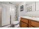 Bathroom showcasing a glass-enclosed shower, wooden vanity with double sinks, and mosaic tile at 3698 Lakeview Drive, Tucker, GA 30084