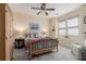 Bright bedroom featuring a ceiling fan, two windows, and carpeted floors at 3698 Lakeview Drive, Tucker, GA 30084