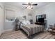 Cozy bedroom with wood floors, a ceiling fan, and a bright window at 3698 Lakeview Drive, Tucker, GA 30084