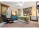 Bedroom featuring a leather chair, blue dresser, and decorative window curtains at 3698 Lakeview Drive, Tucker, GA 30084
