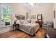 Bedroom with hardwood floors, large windows, and a decorative lamp on a bedside table at 3698 Lakeview Drive, Tucker, GA 30084