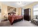 Bedroom with carpeted floors, armoire, large windows, and decorative accents at 3698 Lakeview Drive, Tucker, GA 30084
