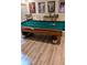 Entertaining game room featuring a billiard table, movie posters, and luxury vinyl plank flooring at 3698 Lakeview Drive, Tucker, GA 30084