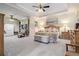 Spacious main bedroom with tray ceiling, sitting area, bookcase, and large windows at 3698 Lakeview Drive, Tucker, GA 30084