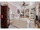 Cozy home office with custom built-in bookshelves, neutral colored walls and a comfy sitting area at 3698 Lakeview Drive, Tucker, GA 30084