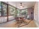 Relaxing screened porch with ceiling fan, table with chairs, and views of the wooded backyard at 3698 Lakeview Drive, Tucker, GA 30084
