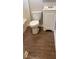 This bathroom features vinyl flooring and a toilet with a white vanity at 6197 Union Grove Rd, Lithia Springs, GA 30122