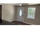 Home entryway with a decorative glass front door and a window that lets in natural light at 6197 Union Grove Rd, Lithia Springs, GA 30122