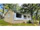 Charming single-story home with mixed siding, black shutters, and a cozy front porch at 6197 Union Grove Rd, Lithia Springs, GA 30122