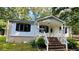 Charming single-story home featuring a brick foundation and a covered front porch with brick steps at 6197 Union Grove Rd, Lithia Springs, GA 30122