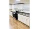 Bright kitchen featuring white cabinets, neutral countertops and backsplash, and stainless steel appliances at 6197 Union Grove Rd, Lithia Springs, GA 30122