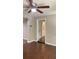 Cozy living room with hardwood floors, a ceiling fan, and an open doorway at 6197 Union Grove Rd, Lithia Springs, GA 30122