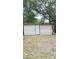 An exterior shed has white siding and a white door and is located in the backyard at 6197 Union Grove Rd, Lithia Springs, GA 30122