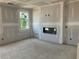 Spacious living room featuring a sleek, modern fireplace and ample natural light at 7226 Lacey Dr Lot 125 Dr, Douglasville, GA 30134