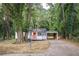 Charming home featuring a covered parking spot and a welcoming front porch with an orange door at 2437 Clarissa Nw Dr, Atlanta, GA 30318