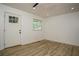 Bright living room featuring modern floors, a window, and a white front door at 2437 Clarissa Nw Dr, Atlanta, GA 30318