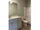Bathroom with a white vanity, large mirror, toilet and shower with tile surround at 3708 Cheswolde Ave # 95, Powder Springs, GA 30127