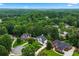 Aerial view of homes in a neighborhood surrounded by lush, mature trees at 5833 Wembley Dr, Douglasville, GA 30135