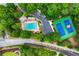 Aerial view of community pool and tennis courts surrounded by mature trees and lush landscaping at 5833 Wembley Dr, Douglasville, GA 30135