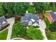 Aerial view of home with beautifully landscaped yard, circular driveway, and mature trees at 5833 Wembley Dr, Douglasville, GA 30135