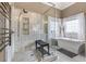 Modern bathroom featuring glass shower, free standing soaking tub, and marble flooring at 5833 Wembley Dr, Douglasville, GA 30135