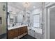 Bathroom featuring double vanity, soaking tub, glass enclosed shower, and marble-like tile at 5833 Wembley Dr, Douglasville, GA 30135