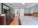 Comfortable bedroom featuring a dresser, hardwood floors, and natural light at 5833 Wembley Dr, Douglasville, GA 30135