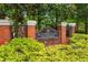 Kensington Swim & Tennis Community sign at brick entrance adorned with lush green landscaping at 5833 Wembley Dr, Douglasville, GA 30135