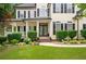 Charming home exterior boasts manicured lawn, lush landscaping, and inviting front porch at 5833 Wembley Dr, Douglasville, GA 30135