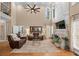 Spacious living room with high ceilings, fireplace, and large windows at 5833 Wembley Dr, Douglasville, GA 30135