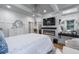Large main bedroom with walk in closet, electric fireplace, decorative wall paneling, and hardwood floors at 5833 Wembley Dr, Douglasville, GA 30135