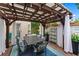 Outdoor patio with a dining table beneath a pergola strung with lights, and white curtains for privacy at 5833 Wembley Dr, Douglasville, GA 30135