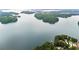Scenic aerial of a lake with wooded islands and shoreline homes at 6381 Lakeview Dr, Buford, GA 30518