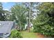 Lush backyard with mature trees and lake views offering a serene and private outdoor space at 6381 Lakeview Dr, Buford, GA 30518
