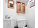 Compact bathroom with a white vanity, toilet, and nautical-themed decor creating a coastal vibe at 6381 Lakeview Dr, Buford, GA 30518