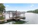 Picturesque dock with boat lift, lounge area, and easy lake access at 6381 Lakeview Dr, Buford, GA 30518