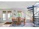 Bright dining area with a spiral staircase, glass doors to an outside terrace and view to the backyard at 6381 Lakeview Dr, Buford, GA 30518
