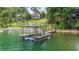 Boat dock featuring a lift and upper deck for lake views at 6381 Lakeview Dr, Buford, GA 30518