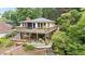 Charming home featuring a spacious deck, lower-level patio, and lush greenery offering an inviting outdoor space at 6381 Lakeview Dr, Buford, GA 30518