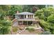 Charming lakeside home with a spacious deck overlooking a green yard at 6381 Lakeview Dr, Buford, GA 30518