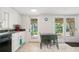 Bright kitchen with white cabinets, green countertop, and access to outdoor entertaining area at 6381 Lakeview Dr, Buford, GA 30518