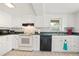 Bright kitchen with white cabinets, modern appliances, and a window with a view at 6381 Lakeview Dr, Buford, GA 30518