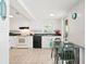 Bright kitchen features white cabinets, green countertops, and dining table with views to the outdoors at 6381 Lakeview Dr, Buford, GA 30518