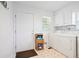 Functional laundry room with washer, dryer, and storage cabinets for convenience at 6381 Lakeview Dr, Buford, GA 30518